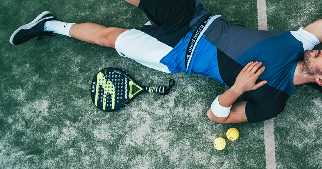Padel Player Lays on the Artificial Grass