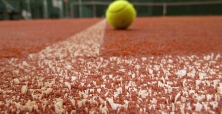 Tennis ball on Advantage Red Court surface